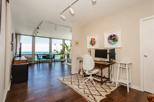 a living room with furniture and wooden floor