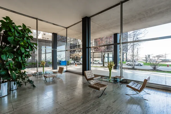 a living room filled with furniture and floor to ceiling windows