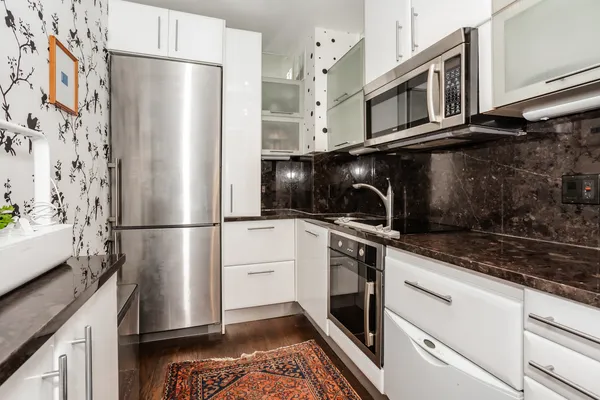 a kitchen with stainless steel appliances a refrigerator a stove a microwave and cabinets