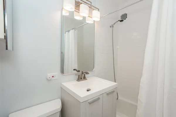 a bathroom with a sink toilet and shower