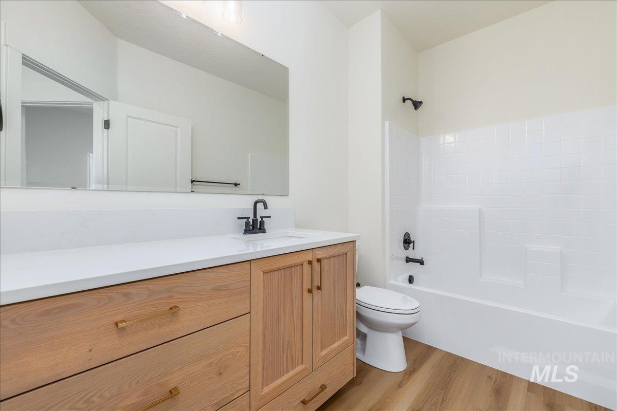 775 Pinehurst Street Payette, ID 83661 - Photo 17 of 36 Bathroom featuring vanity, light wood-type flooring, and bathing tub / shower combination