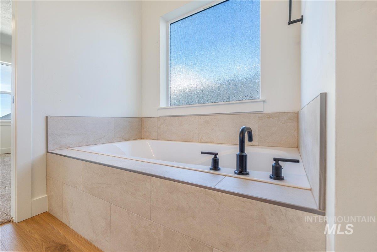 775 Pinehurst Street Payette, ID 83661 - Photo 21 of 36 Bathroom with a bath and light wood-style floors
