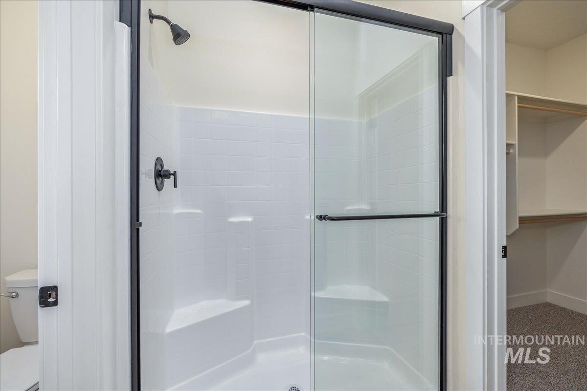 775 Pinehurst Street Payette, ID 83661 - Photo 22 of 36 Bathroom featuring a shower stall, a spacious closet, and carpet flooring