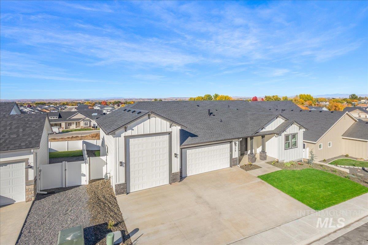 775 Pinehurst Street Payette, ID 83661 - Photo 35 of 36 Modern farmhouse featuring a shingled roof, board and batten siding, a residential view, driveway, and an attached garage