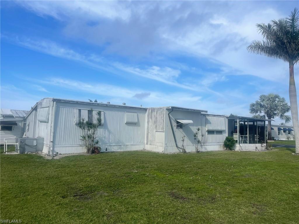 85 Enchanting Boulevard, Unit E85 Naples, FL 34112 - Photo 13 of 15 a front view of a house with garden
