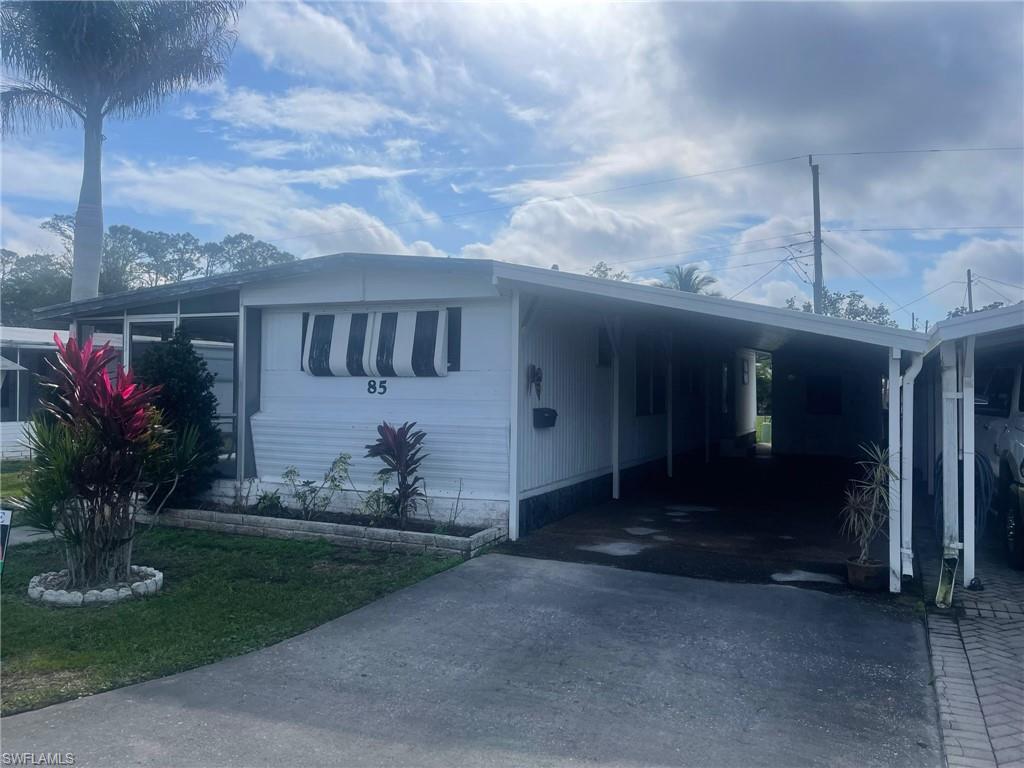 85 Enchanting Boulevard, Unit E85 Naples, FL 34112 - Photo 15 of 15 a front view of a house with garden