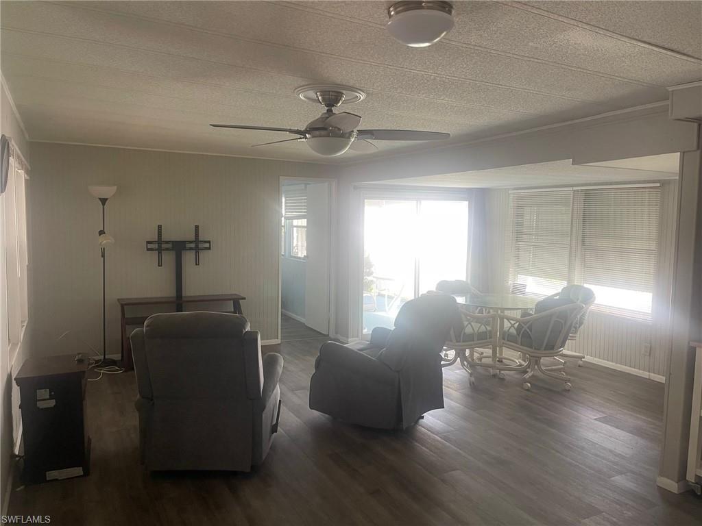 85 Enchanting Boulevard, Unit E85 Naples, FL 34112 - Photo 2 of 15 a living room with furniture and wooden floor