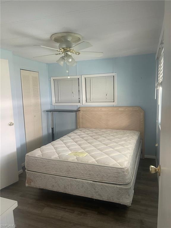 85 Enchanting Boulevard, Unit E85 Naples, FL 34112 - Photo 4 of 15 a bedroom with a bed and wooden floor