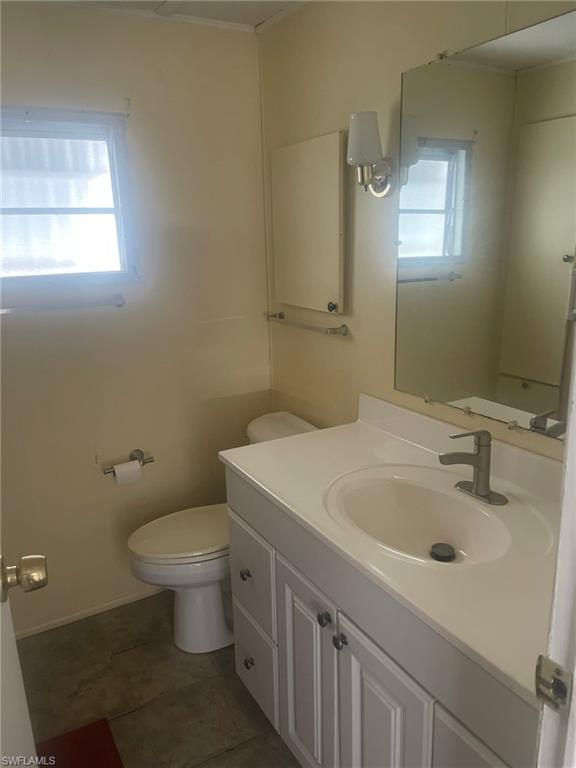 85 Enchanting Boulevard, Unit E85 Naples, FL 34112 - Photo 7 of 15 a bathroom with a sink toilet and vanity