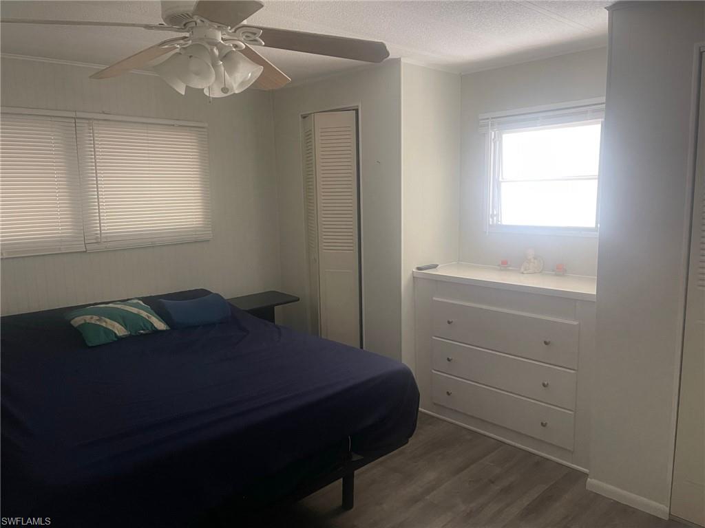 85 Enchanting Boulevard, Unit E85 Naples, FL 34112 - Photo 8 of 15 a bedroom with a bed and a window