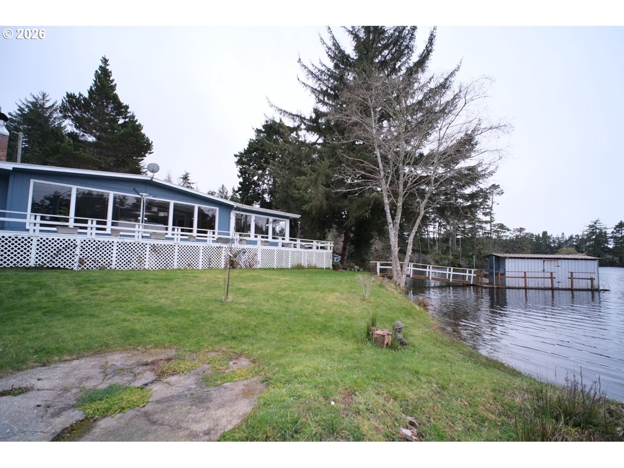 70214 Lakewood Road North Bend, OR 97459 - Photo 34 of 39 a view of a house with a backyard
