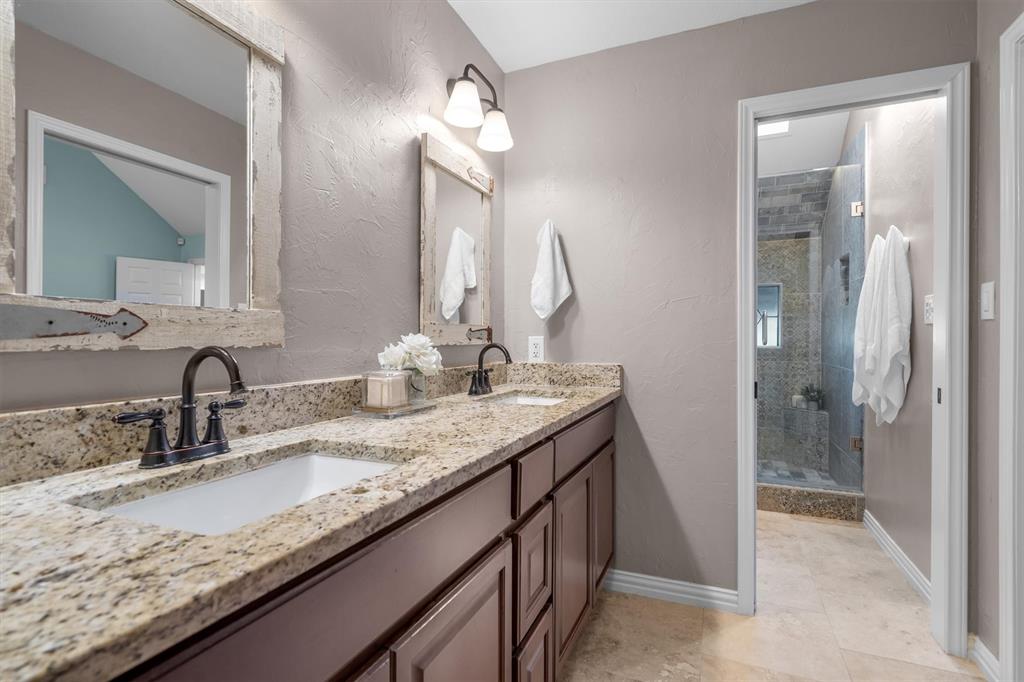 410 Simmons Road Double Oak, TX 75077 - Photo 19 of 40 Double vanity and elegant walk-in shower make this bath feel like a private spa.