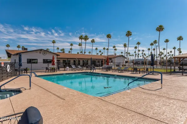 a swimming pool with outdoor seating and yard