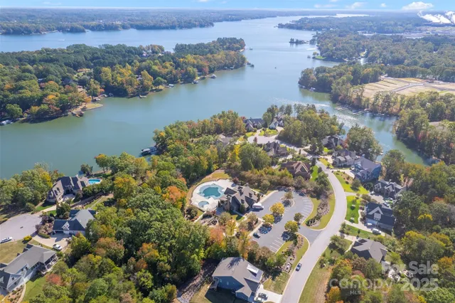 an aerial view of lake and residential houses with outdoor space