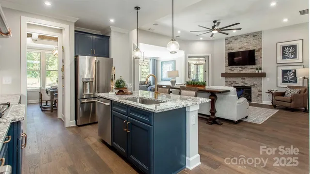 a kitchen with stainless steel appliances granite countertop a stove and a refrigerator