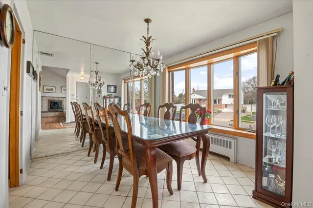 a dining room with furniture a chandelier and fireplace
