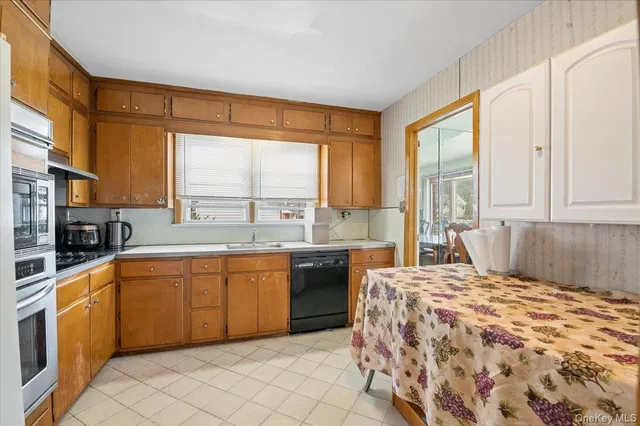 a large kitchen with a window and cabinets