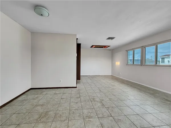 a view of a livingroom with an empty space and window