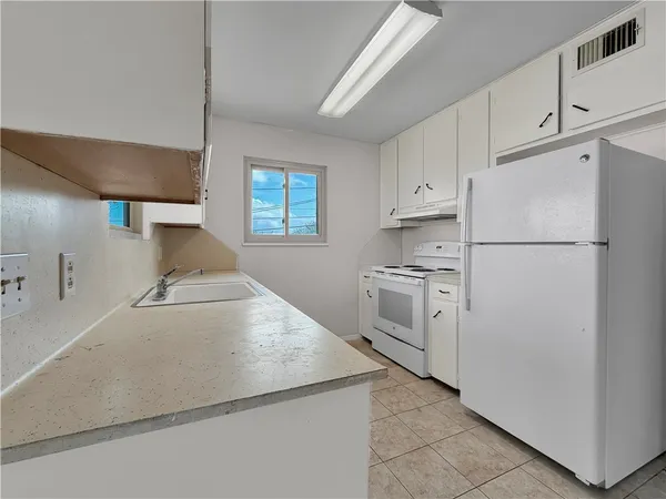 a white refrigerator freezer sitting inside of a kitchen