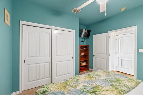 a view of a bedroom with closet and cabinet