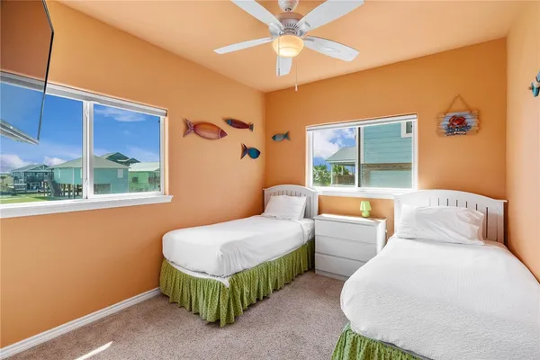 a bedroom with a bed a mirror and a window