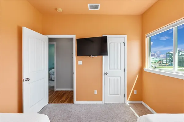 a living room with a couch and a dresser