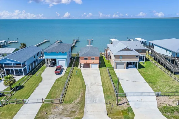 a aerial view of a house with a yard table and chairs