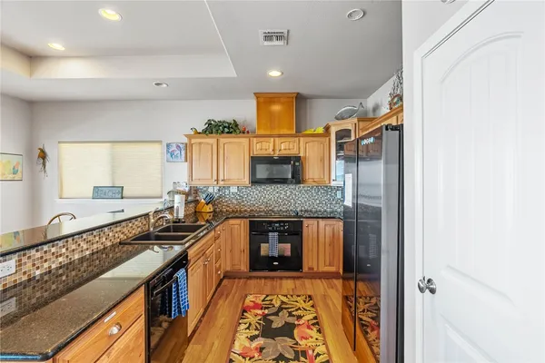 a kitchen with stove and cabinets