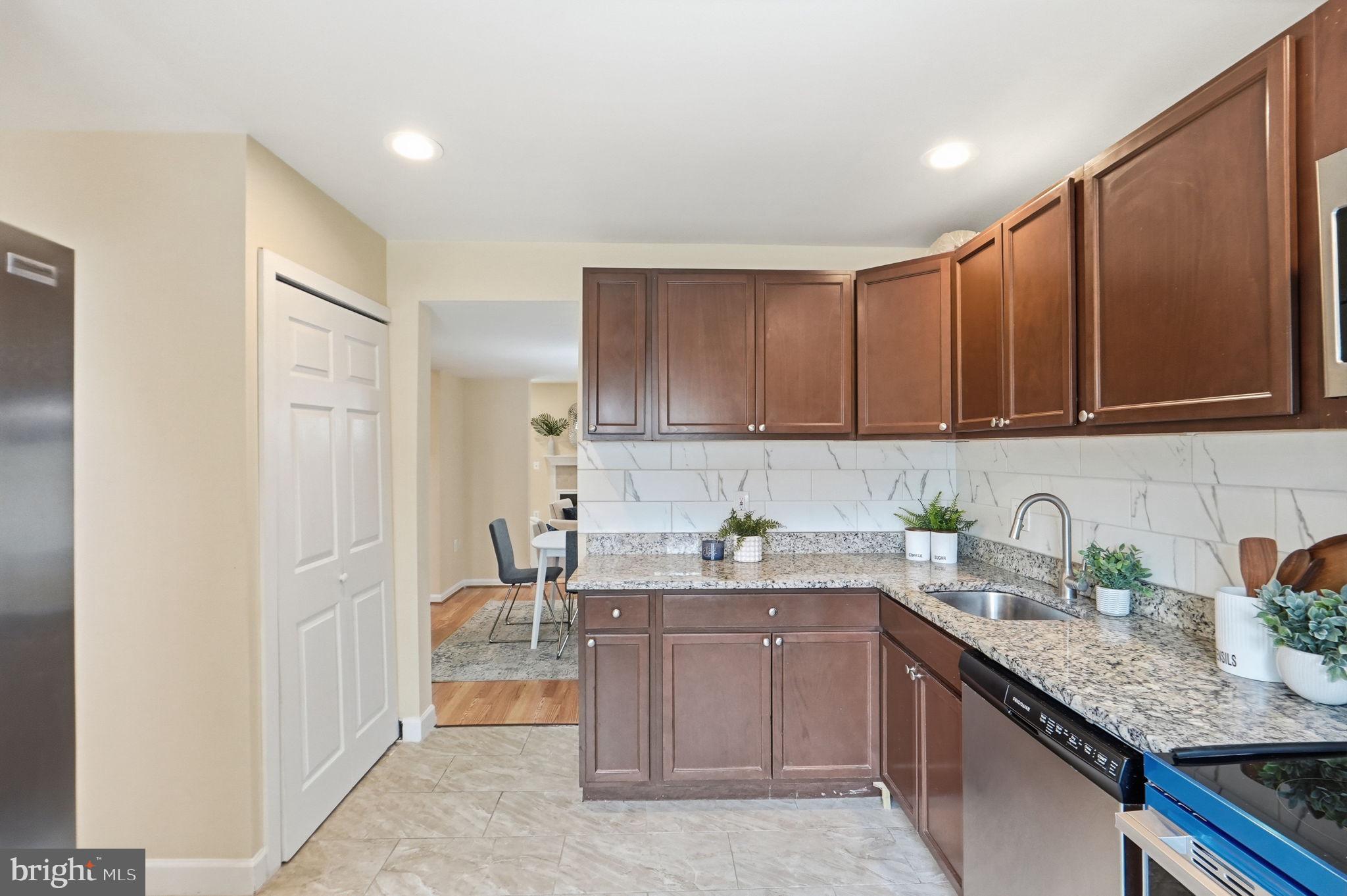 6470 Franconia Court Springfield, VA 22150 - Photo 6 of 31 a kitchen with stainless steel appliances granite countertop a sink stove and cabinets