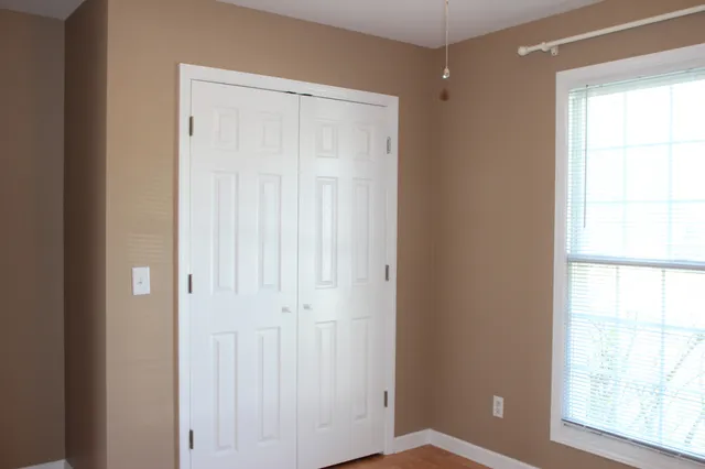 a bathroom with a granite countertop toilet and a sink