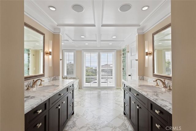 a bathroom with a tub a sink and mirror