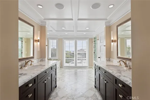 a bathroom with a tub a sink and mirror