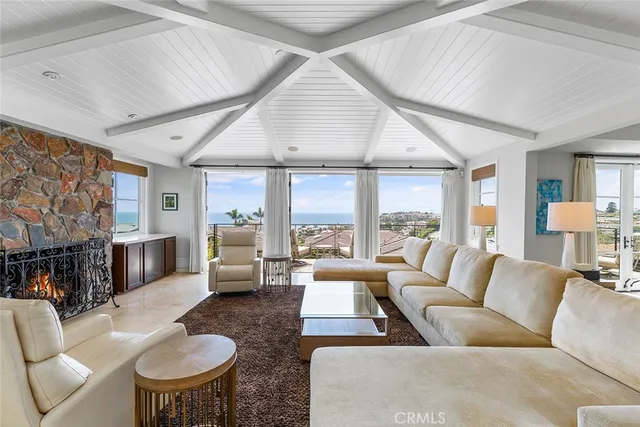 a view of a dining room with furniture large windows and wooden floor