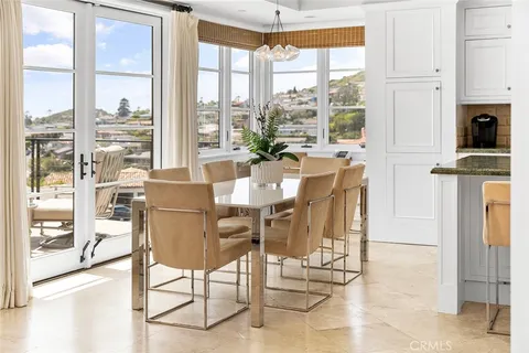 a kitchen with granite countertop white cabinets sink and stove