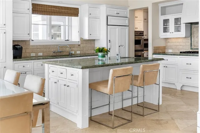 a dining room with furniture a chandelier and wooden floor