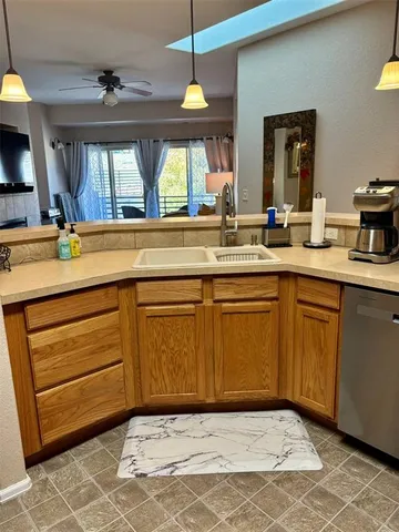 a kitchen with a sink cabinets and window
