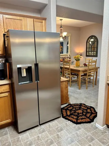 a kitchen with stainless steel appliances granite countertop a refrigerator and a stove