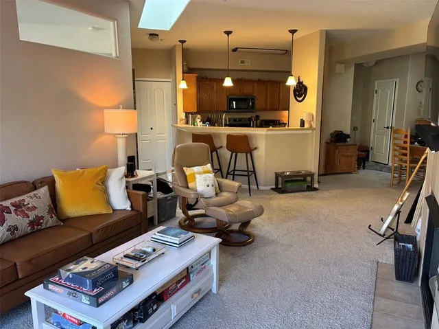 a living room with furniture gym equipment and a chandelier