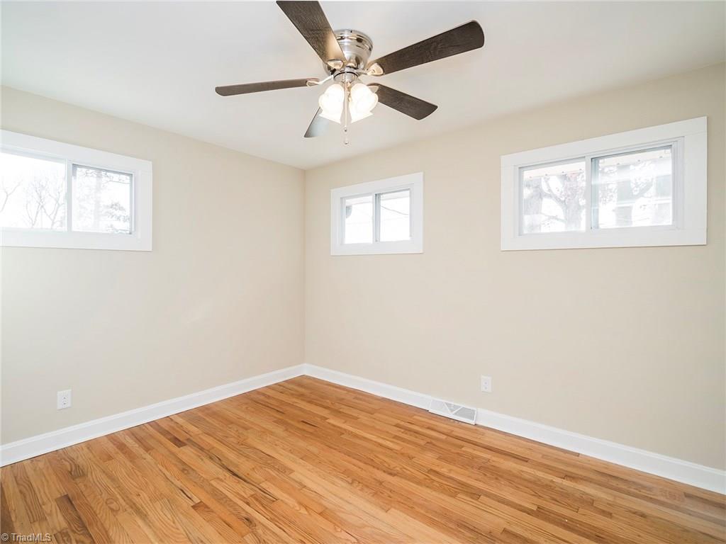 209 Edgeview Road High Point, NC 27260 - Photo 14 of 20 Large fourth bedroom with hard wood floors throughout. Tons of natural lighting, ceiling fan and large closet. Easy access to hall bath.