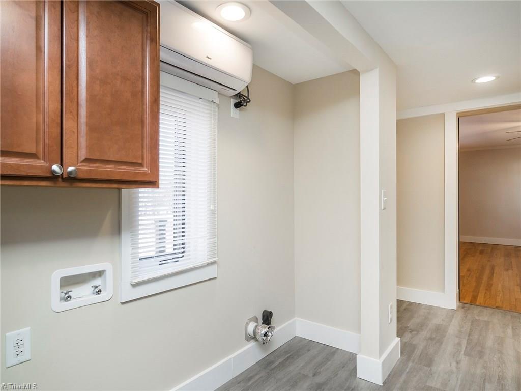 209 Edgeview Road High Point, NC 27260 - Photo 15 of 20 Large laundry room with washer and dryer connections. Cabinets for added storage space, easy to maintain laminate flooring, direct access to 2 car attache garage and back deck.