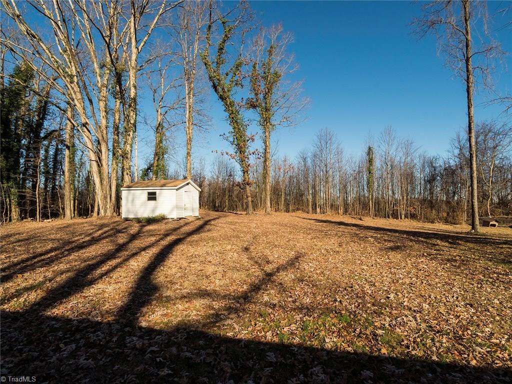 209 Edgeview Road High Point, NC 27260 - Photo 19 of 20 Spacious back yard with storage building, tons of trees for added shade and privacy.