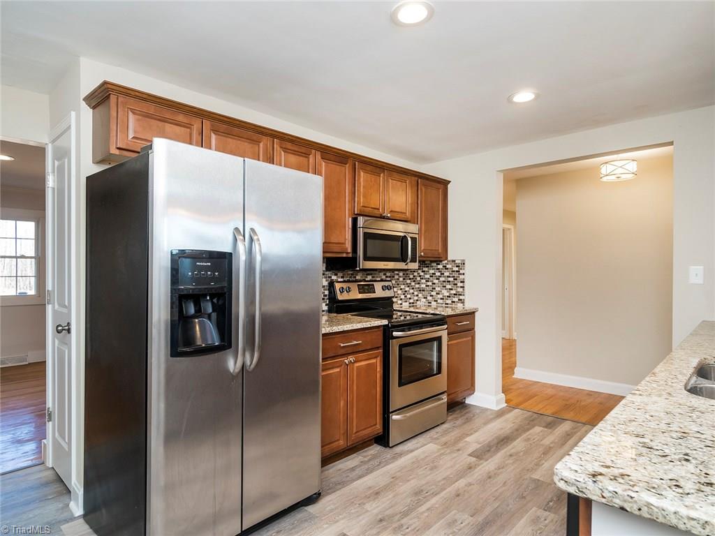 209 Edgeview Road High Point, NC 27260 - Photo 4 of 20 Beautiful updated kitchen with tons of counter and storage space. Easy to maintain laminate flooring, accent lighting, and windows over sink for added natural lighting.