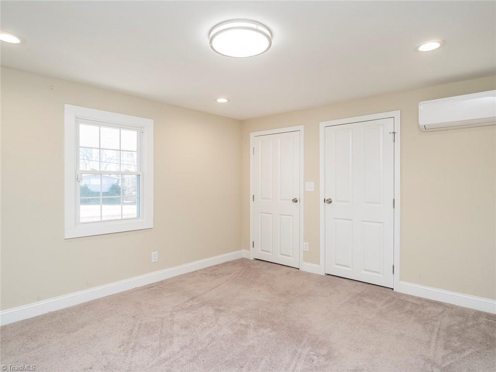 209 Edgeview Road High Point, NC 27260 - Photo 6 of 20 Large master bedroom with carpet throughout. Two closets, large windows for added natural lighting, accent lighting, easy access to master bath and laundry room.