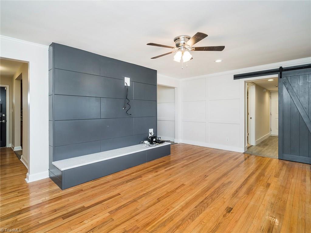 209 Edgeview Road High Point, NC 27260 - Photo 8 of 20 Large living room with beautiful hard wood floors throughout. Large windows for added natural lighting, ceiling fan, barn door separating laundry room, master bedroom and garage. Easy access to hall bath and kitchen.