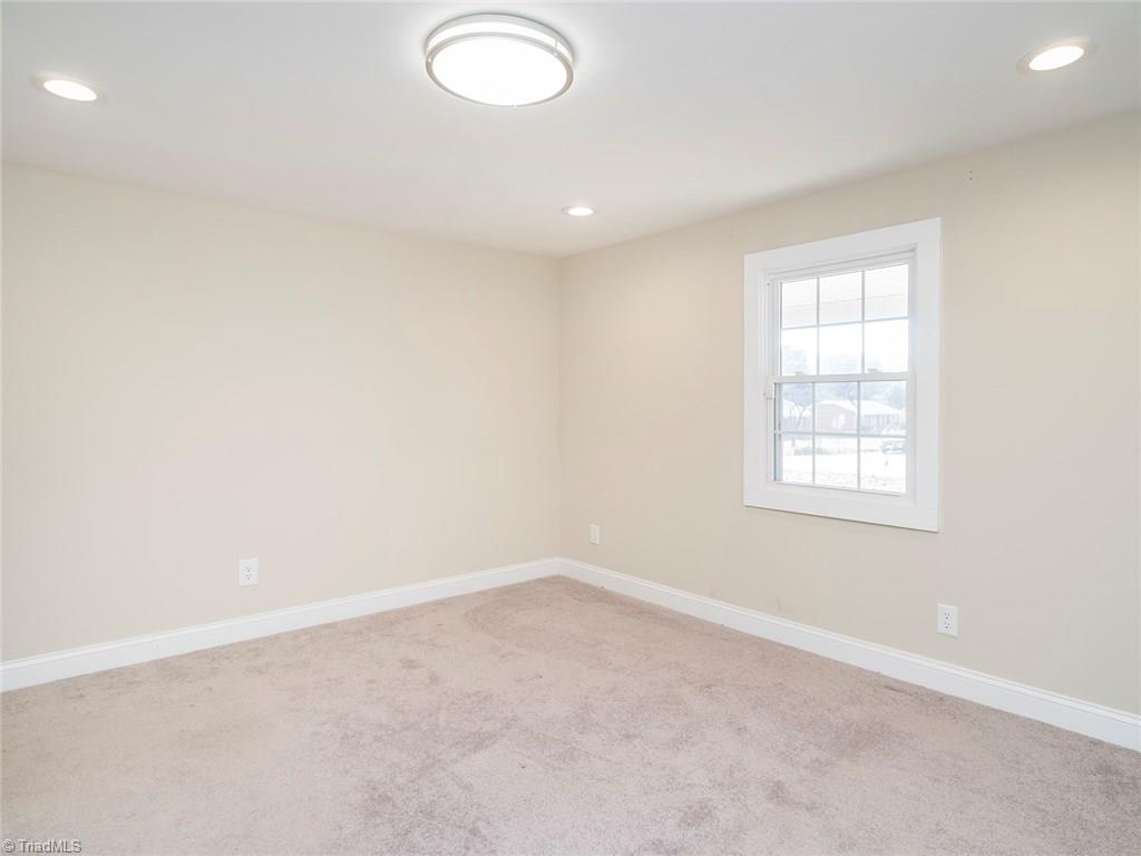 209 Edgeview Road High Point, NC 27260 - Photo 9 of 20 Spacious master bedroom with carpet throughout. Large windows for natural light, accent lighting, double closets, easy access to master bath, and laundry room.