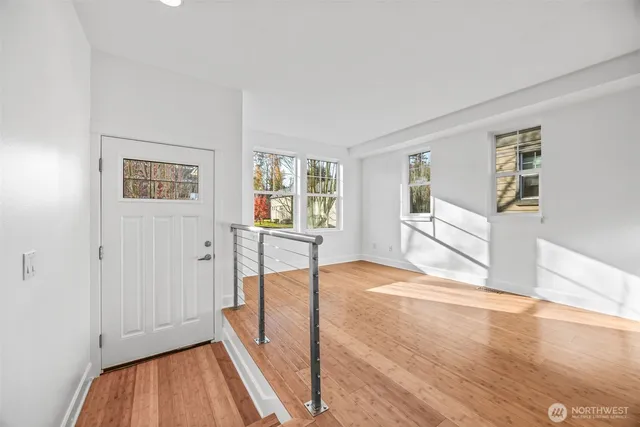 a view of a livingroom with wooden floor and a flat screen tv