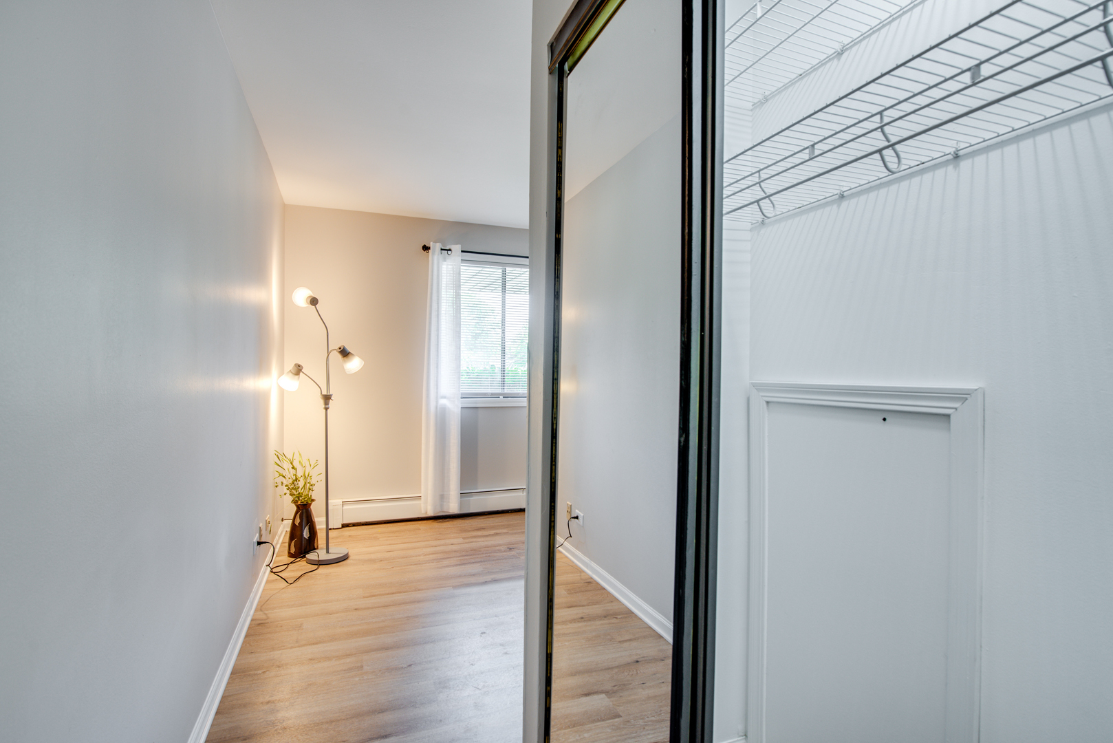 420 Echo Lane, Unit 101 Aurora, IL 60504 - Photo 13 of 16 a view of a room with wooden floor and a bathroom