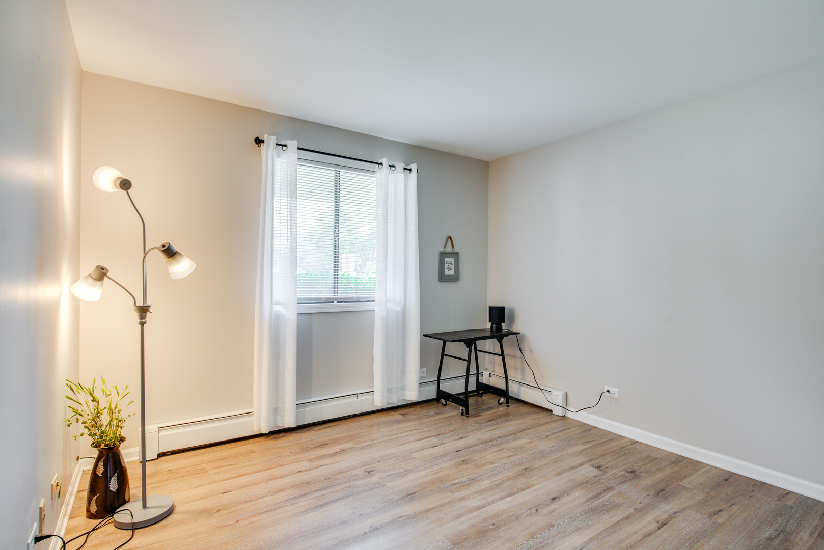 420 Echo Lane, Unit 101 Aurora, IL 60504 - Photo 14 of 16 a view of empty room with wooden floor and fan