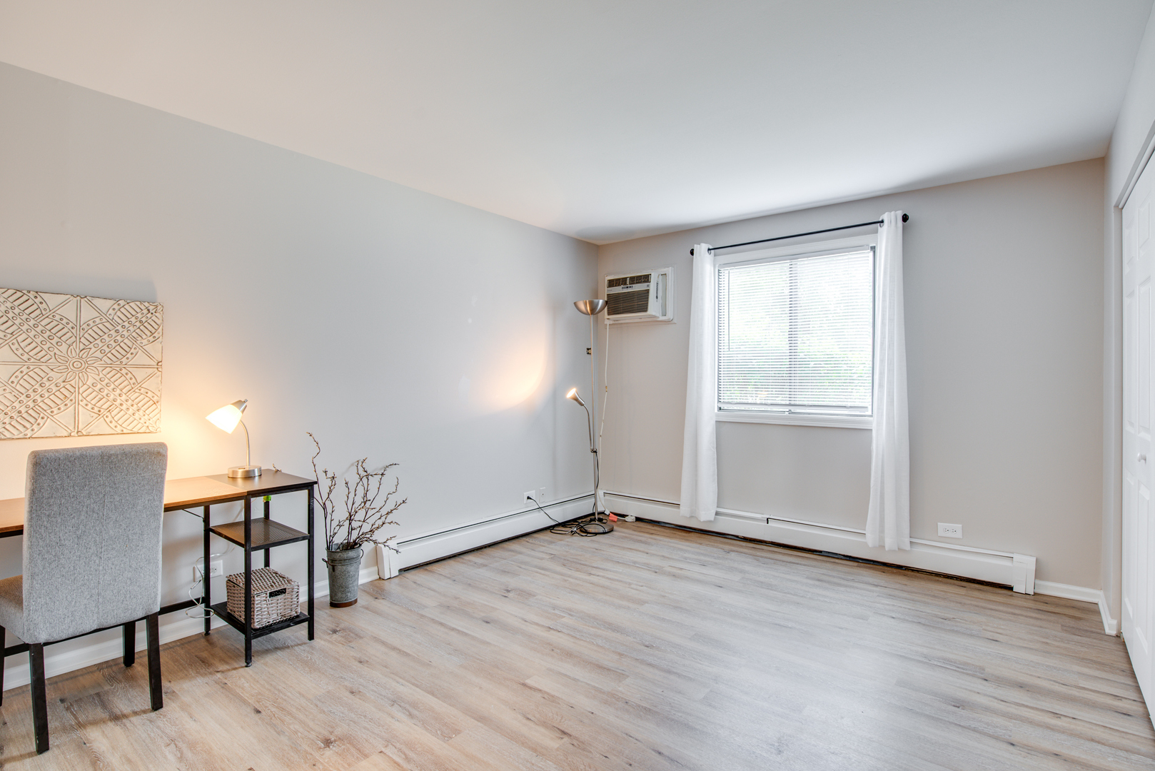 420 Echo Lane, Unit 101 Aurora, IL 60504 - Photo 5 of 16 a view of an empty room with wooden floor and a window