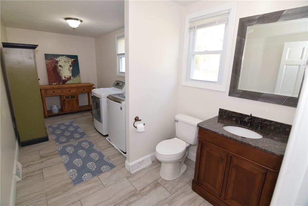 8 Lima Drive Westerly, RI 02891 - Photo 10 of 42 1st floor laundry, 1/2 bath and pantry area just off of garage and kitchen.